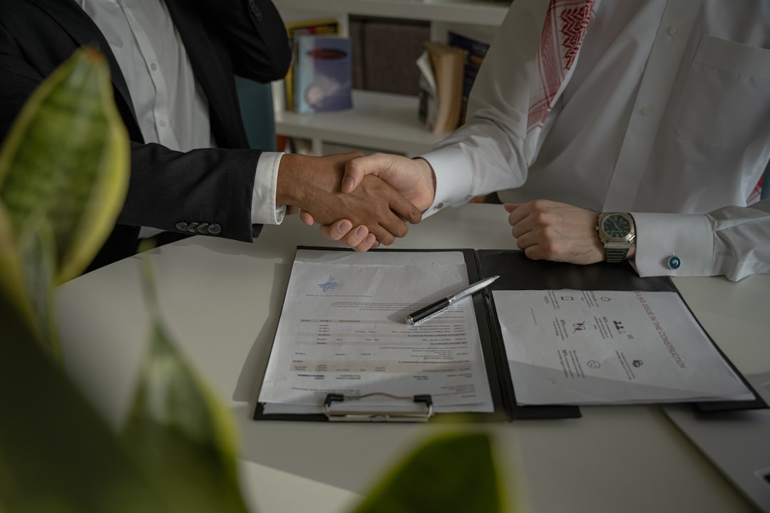 Homeowner and contractor reviewing a detailed remodeling contract before signing