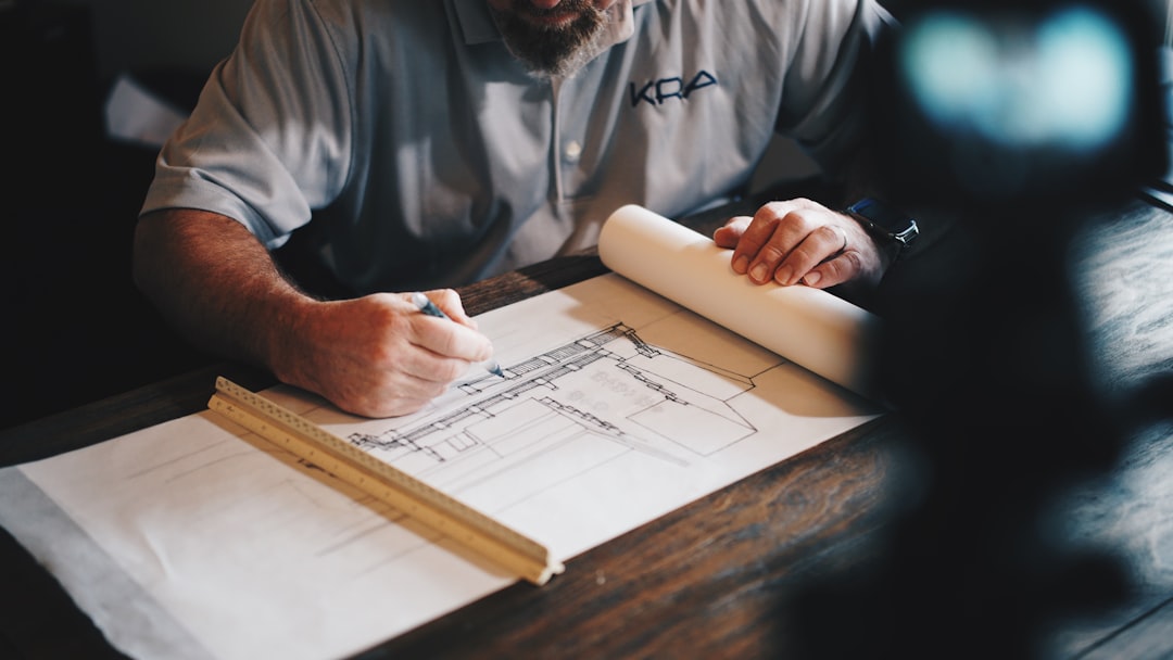Luxury remodeling contractor reviewing architectural drawings during a design consultation