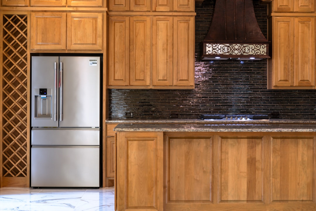 Custom cabinet installation detail with stainless steel appliances in a luxury kitchen