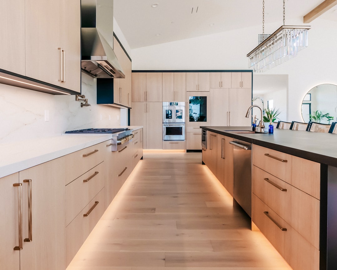 Custom cabinets vs stock cabinets in a contemporary luxury kitchen with flat-panel wood cabinetry