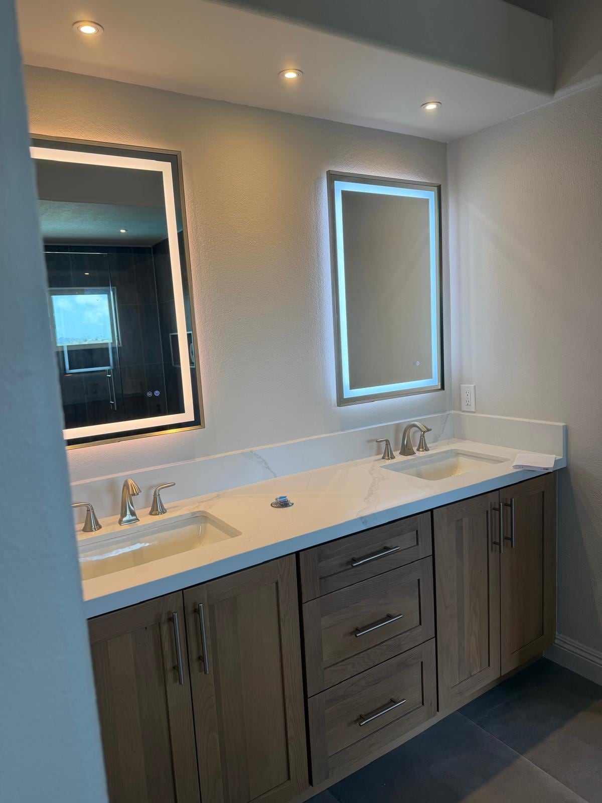 Double vanity with backlit mirrors after a Mission Viejo bathroom remodel
